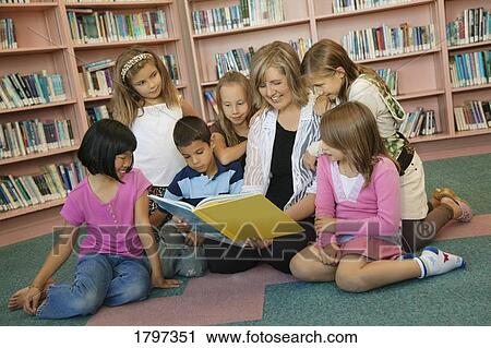 Children being read to in a library View Large Photo Image Stock Image - Children being read to in a library. Fotosearch