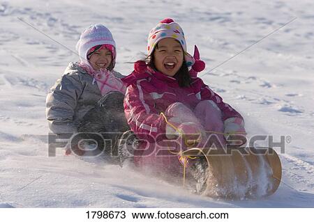 Stock Image - Children tobogganing. Fotosearch