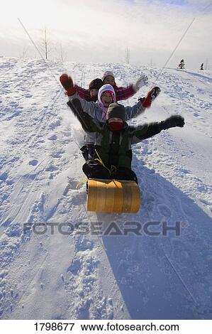 Stock Photo - Children tobogganing. Fotosearch