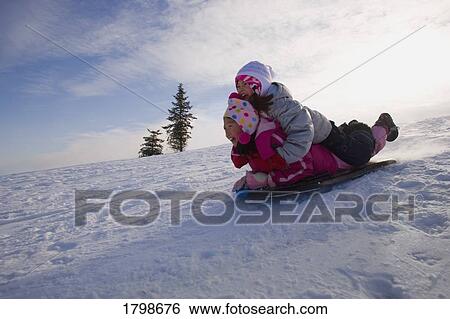 Stock Photograph - Children tobogganing. Fotosearch