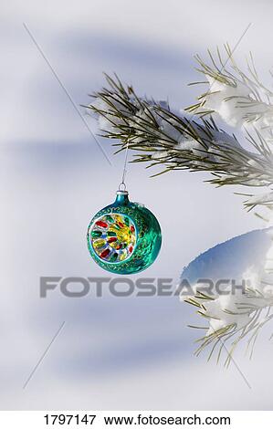 Stock Photo - Christmas ornament hanging from a tree. Fotosearch