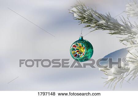 Stock Photo - Christmas ornament hanging on a tree. Fotosearch