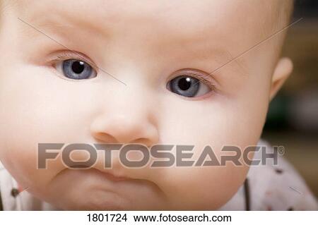 Picture - Close up of baby face. Fotosearch