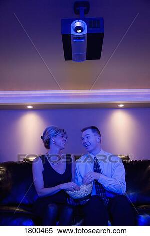 Couple looking at each other in front of movie View Large Photo Image Stock Photography - Couple looking at each other in front of movie. Fotosearch