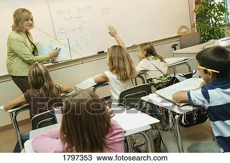 Stock Image - Elementary classroom with teacher and students. Fotosearch