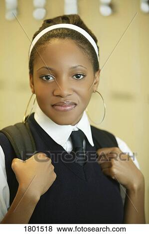Stock Photo - Female student in uniform with backpack on. Fotosearch