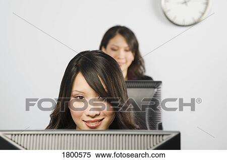 Stock Photography - Females in front of monitors. Fotosearch