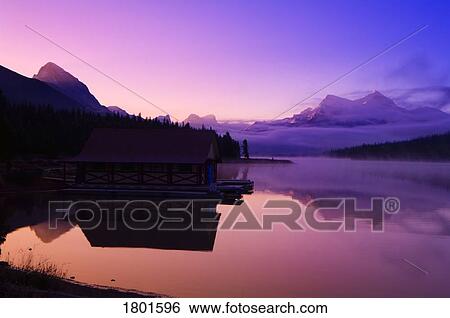 Foggy mountain sunrise on a lake View Large Photo Image Stock Photograph - Foggy mountain sunrise on a lake . Fotosearch