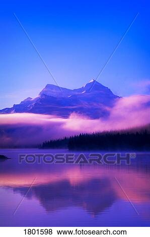 Stock Photo - Foggy mountain sunrise. Fotosearch