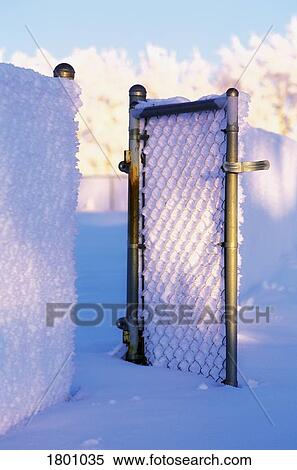 Stock Photography - Gate covered with snow. Fotosearch