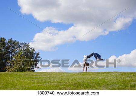 Stock Image - Girl doing a back flip. Fotosearch