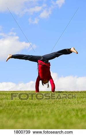 Stock Photo - Girl doing a handstand. Fotosearch