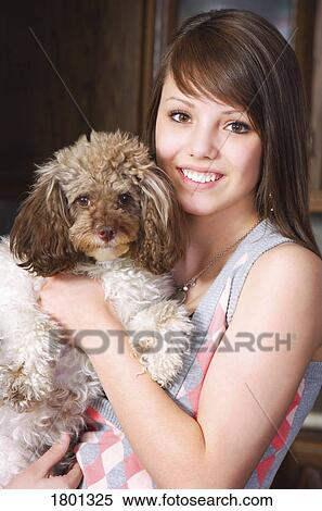 Stock Photography - Girl holding her dog. Fotosearch