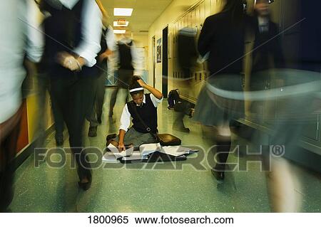 Girl in crowded school hallway with books on the floor View Large Photo Image Stock Photography - Girl in crowded school hallway with books on the floor. Fotosearch