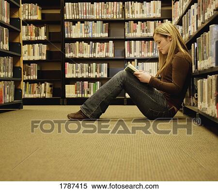Girl reading in a library View Large Photo Image Stock Photography - Girl reading in a library. Fotosearch