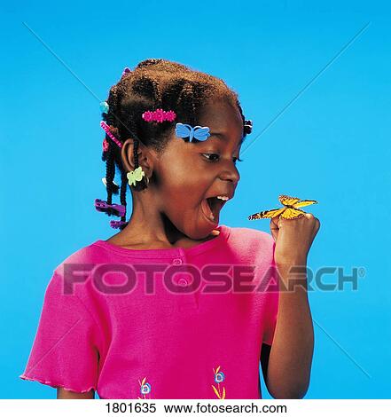 Stock Photography - Girl with a butterfly on her hand. Fotosearch