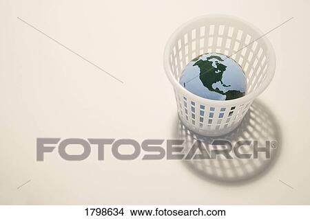 Globe in a trash bin View Large Photo Image Picture - Globe in a trash bin. Fotosearch