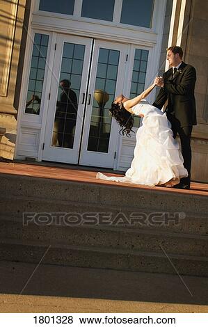 Stock Photo - Groom dancing with bride. Fotosearch