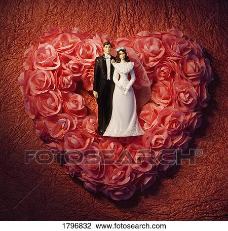Heart-shaped floral wreath with bride and groom figurines View Large Photo Image Stock Image - Heart-shaped floral wreath with bride and groom figurines. Fotosearch