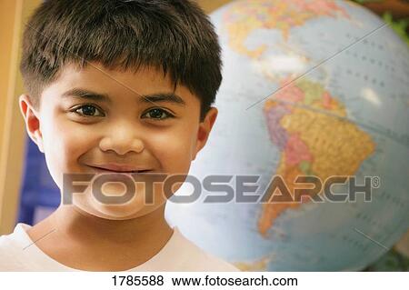 Stock Photo - Hispanic boy and globe. Fotosearch