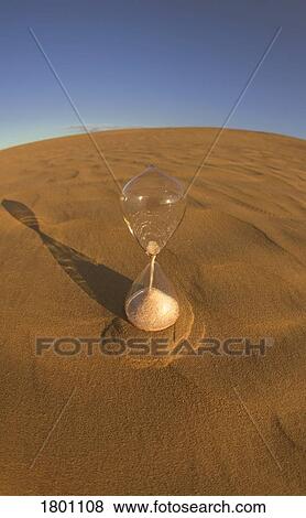 Stock Photo - Hourglass in Desert . Fotosearch