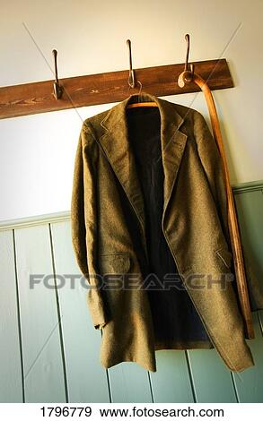 Jacket and cane hanging from coat hooks View Large Photo Image Stock Photo - Jacket and cane hanging from coat hooks. Fotosearch