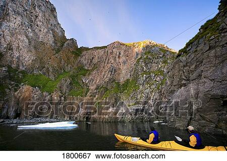 Stock Photo - Kayakers on mountain lake. Fotosearch