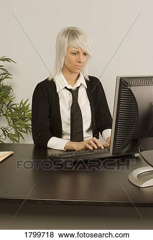 Lady working at a computer View Large Photo Image Stock Photo - Lady working at a computer. Fotosearch