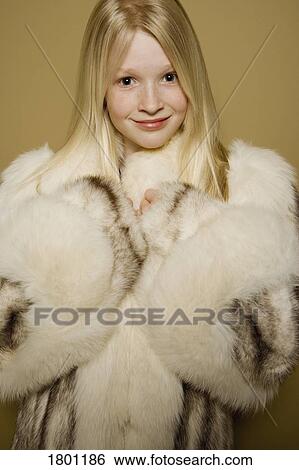 Little girl in a large fur coat View Large Photo Image Stock Photograph - Little girl in a large fur coat. Fotosearch