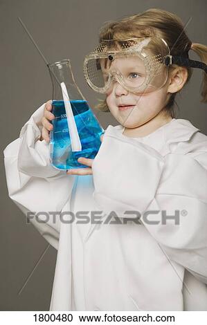 Stock Image - Little girl in safety glasses, holding beaker. Fotosearch