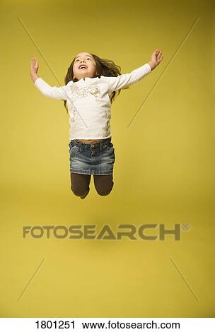 Stock Image - Little girl jumping. Fotosearch