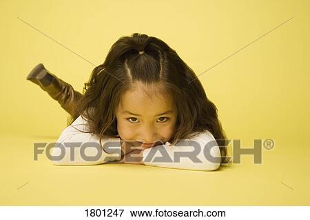 Little girl laying on tummy View Large Photo Image Stock Photo - Little girl laying on tummy. Fotosearch