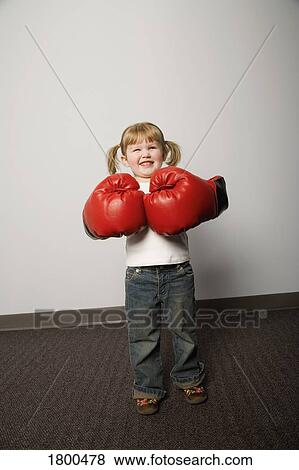 Stock Photo - Little girl with boxing gloves. Fotosearch