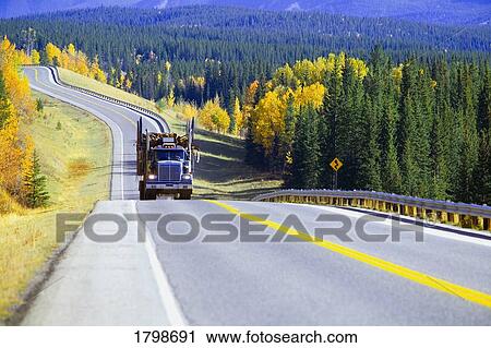 Stock Image - Logging truck in Alberta, Canada. Fotosearch