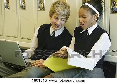Stock Photography - Male and female private school students studying in the hallway. Fotosearch