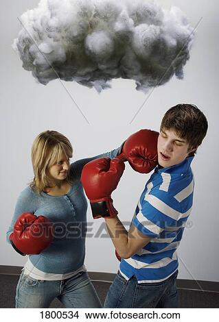 Male and female with boxing gloves under cloud View Large Photo Image Picture - Male and female with boxing gloves under cloud. Fotosearch