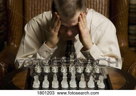 Man concentrating on a chess game View Large Photo Image Stock Image - Man concentrating on a chess game. Fotosearch