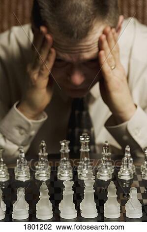 Man concentrating on chess game View Large Photo Image Stock Image - Man concentrating on chess game. Fotosearch