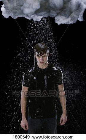 Stock Photo - Man in rain under dark cloud. Fotosearch