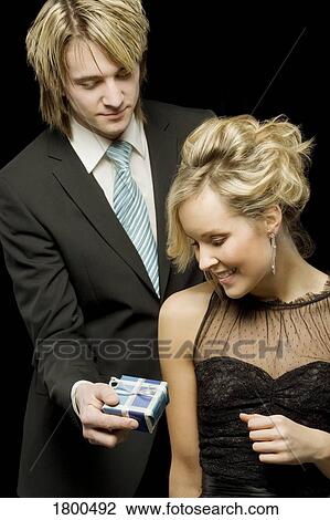 Stock Image - Man offering a gift to woman. Fotosearch