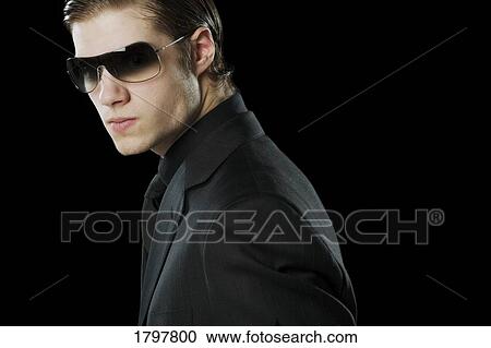 Man wearing a suit and sunglasses View Large Photo Image Stock Image - Man wearing a suit and sunglasses. Fotosearch