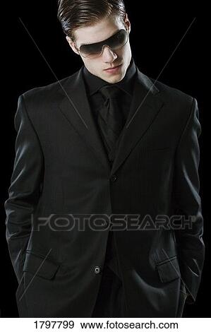 Stock Photo - Man wearing a suit and sunglasses. Fotosearch