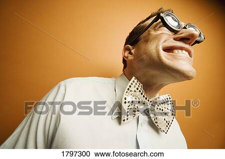 Stock Image - Man wearing thick glasses and a bow tie. Fotosearch
