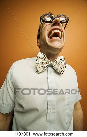 Stock Image - Man wearing thick glasses and a bow tie. Fotosearch