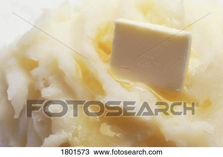 Stock Image - Mashed potatoes with butter melting on them. Fotosearch