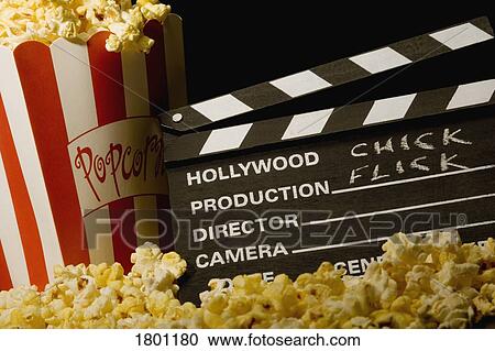 Stock Image - Movie clapboard with popcorn. Fotosearch