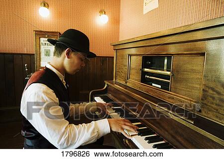 Musician playing old fashioned piano View Large Photo Image Stock Photograph - Musician playing old fashioned piano. Fotosearch