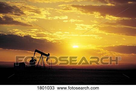 Stock Image - Oil well in a sunset. Fotosearch