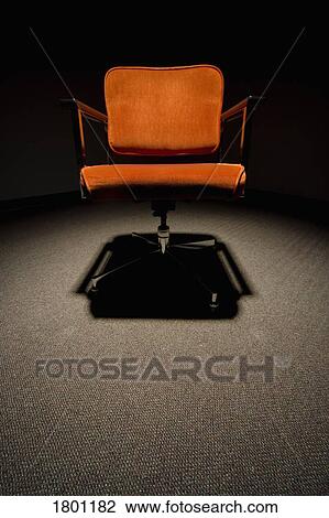 Orange office chair in the spotlight View Large Photo Image Stock Image - Orange office chair in the spotlight. Fotosearch