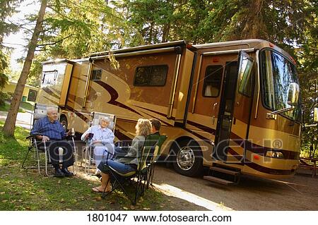 People sitting near recreational vehicle View Large Photo Image Stock Photo - People sitting near recreational vehicle. Fotosearch